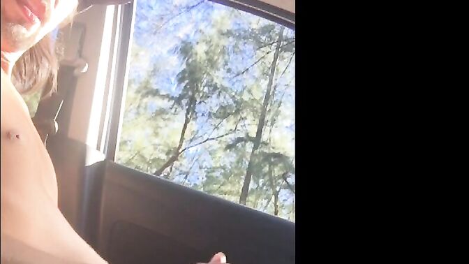 Young surfer tugging hard in his car